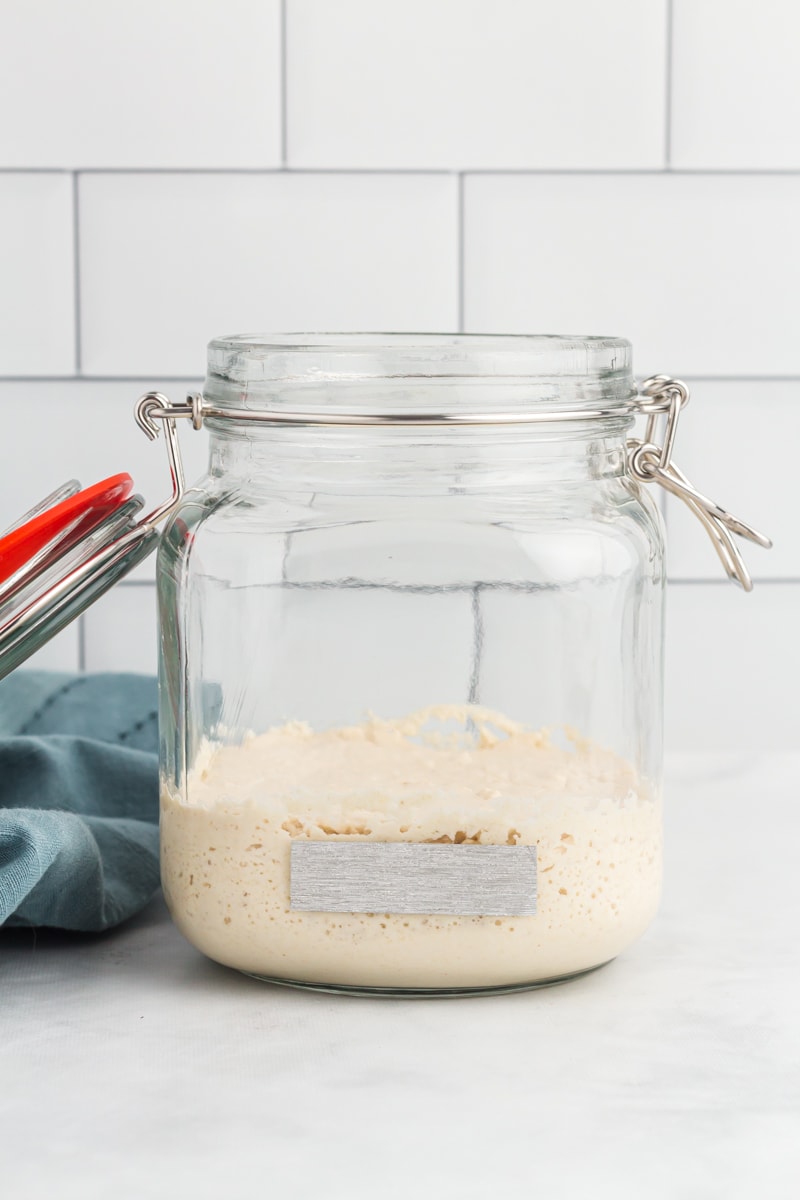 Gluten-Free Sourdough Starter in glass jar with tape on the jar