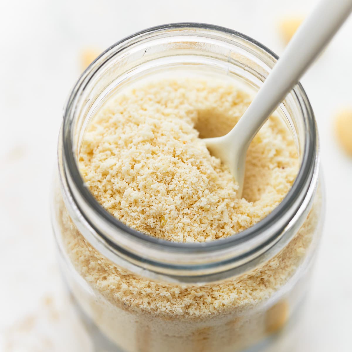 almond flour in a mason jar with a spoon.