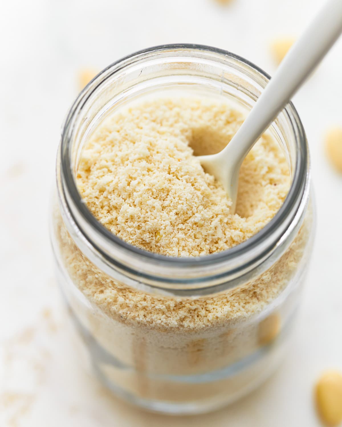 almond flour in a mason jar with a spoon.