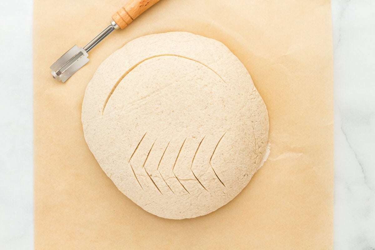 gluten-free sourdough bread dough scored with a lame.