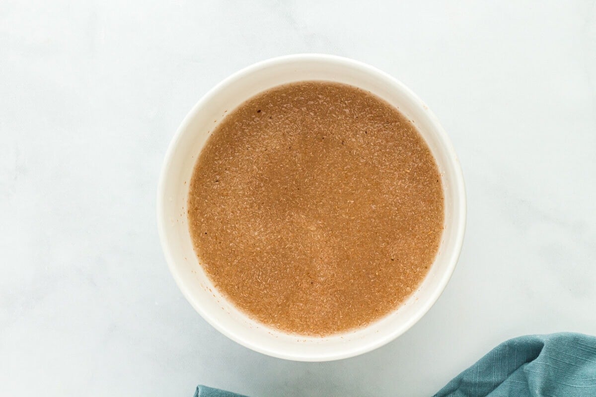 wet ingredients for gluten free sourdough bread in a white bowl.