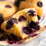 close-up view of a bitten almond flour blueberry muffin.