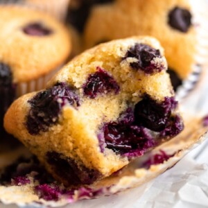 close-up view of a bitten almond flour blueberry muffin.