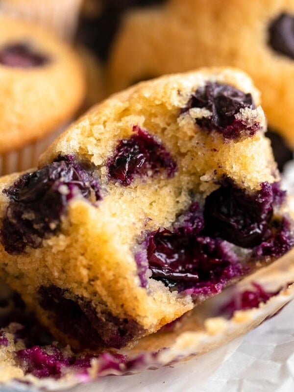 close-up view of a bitten almond flour blueberry muffin.