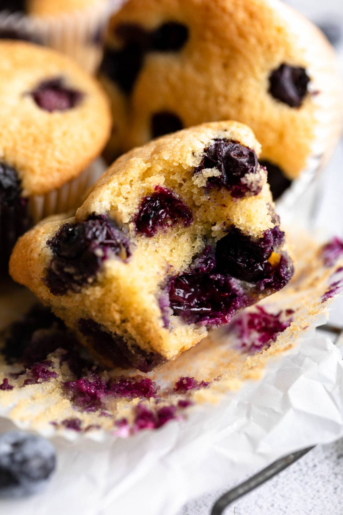 close-up view of a bitten almond flour blueberry muffin.