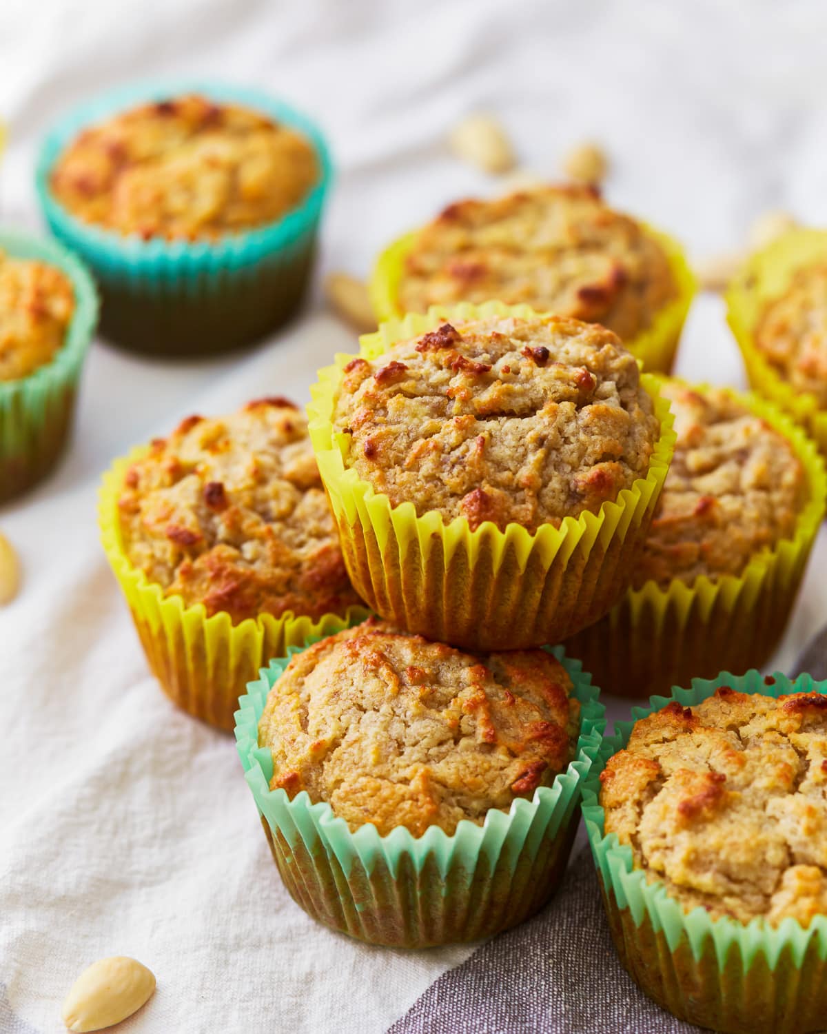 stacked almond flour banana muffins in colorful cupcake liners.