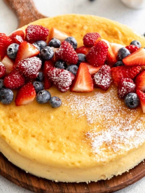 crustless cheesecake on cutting board with fruit