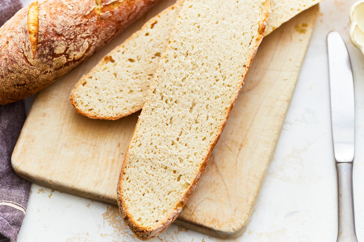 close-up view of a gluten-free baguette sliced lengthwise to show the crumb.