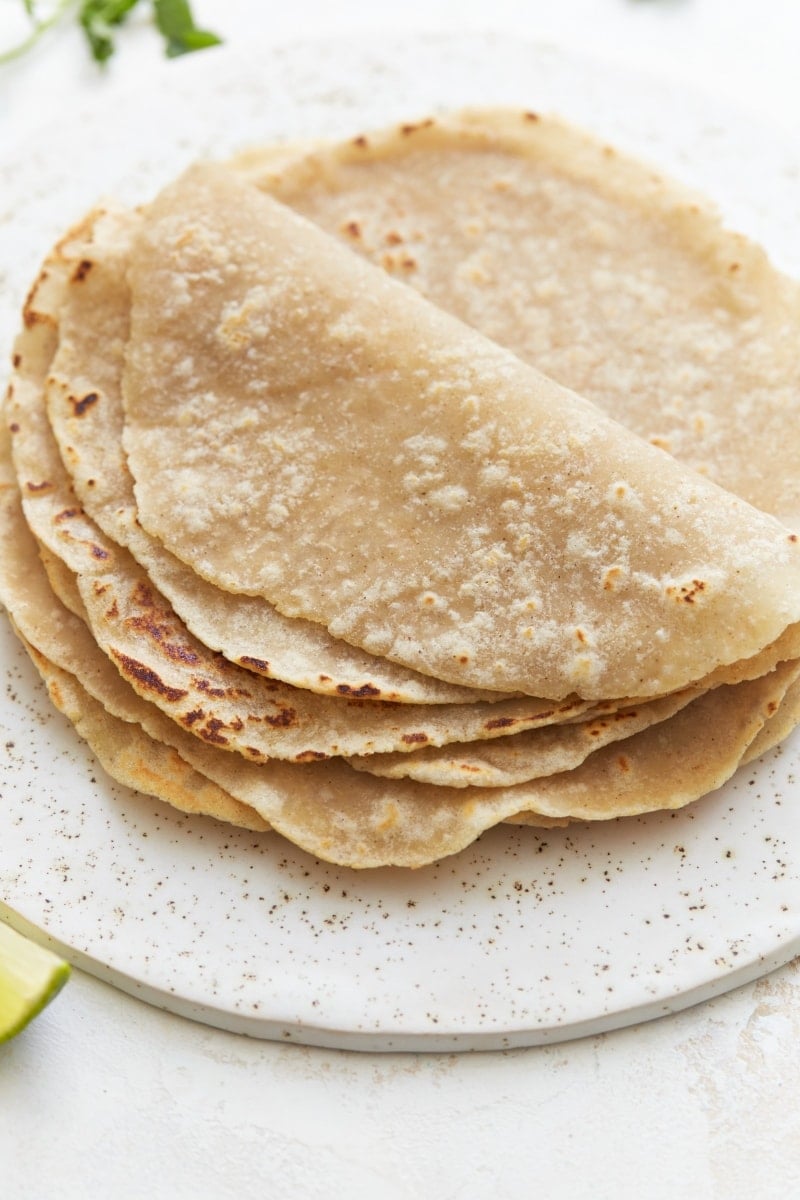 gluten-free tortillas folded on a white plate