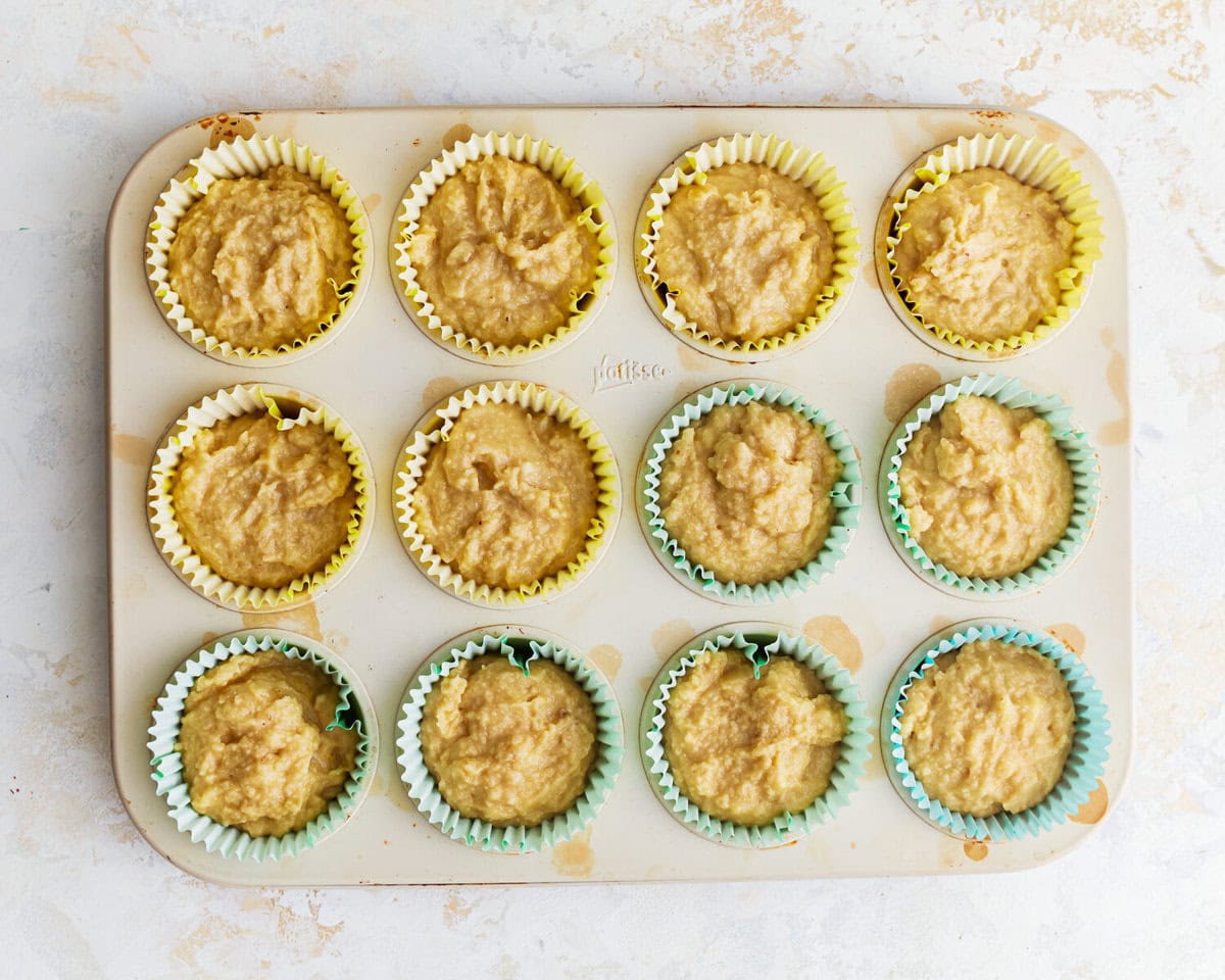 overhead view of almond flour banana muffin batter in a muffin tin.