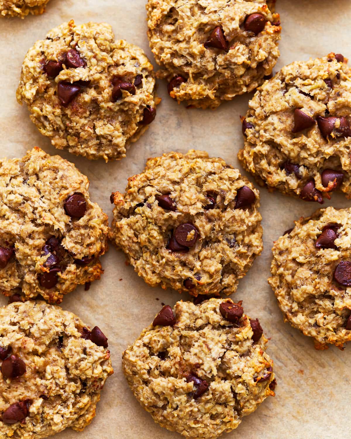 close up overhead view of banana oatmeal cookies on parchment paper.