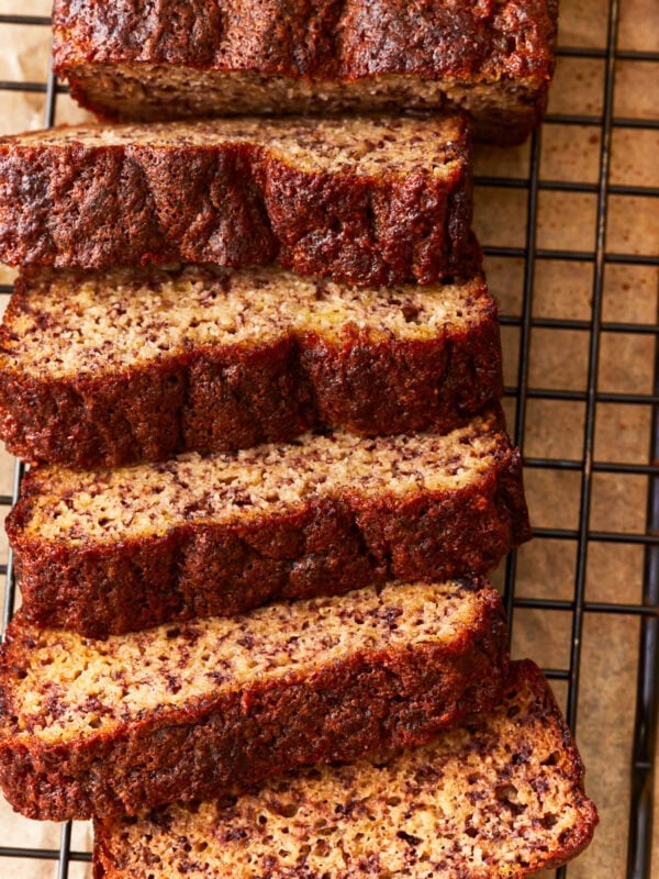 overhead view of a sliced loaf of coconut flour banana bread on a wire rack.