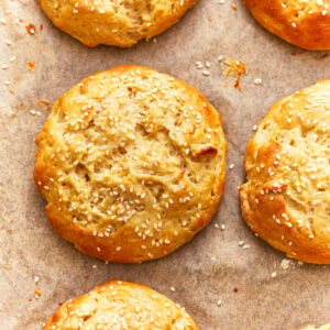 overhead view of gluten-free hamburger buns on parchment.