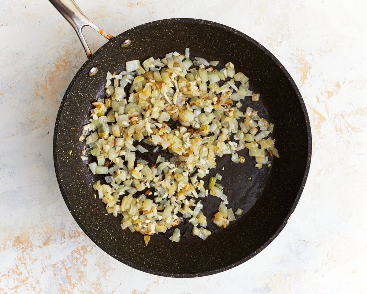 Onions cooking in a skillet.