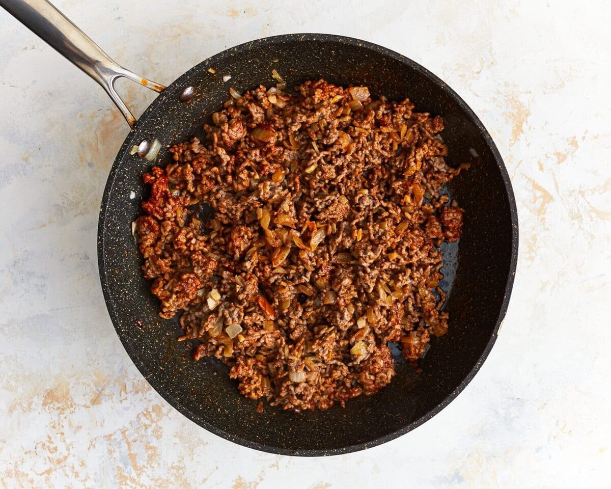 Cooked ground beef in a skillet.