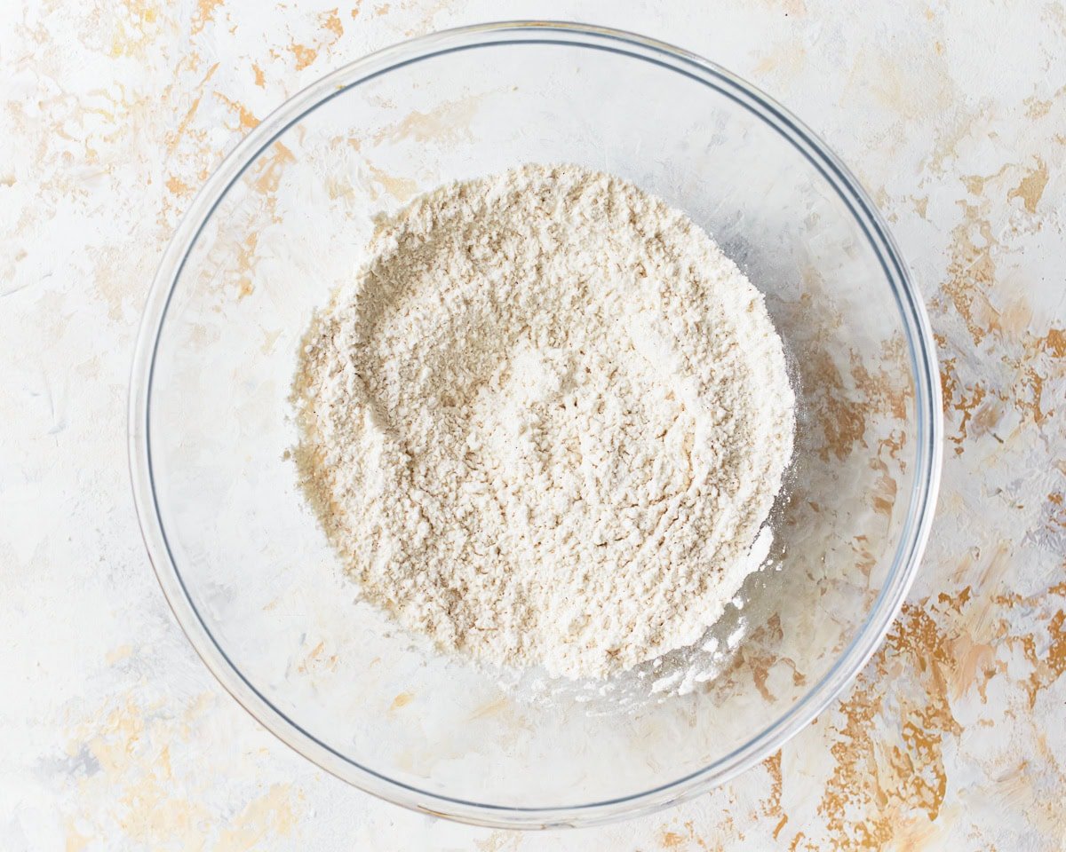 Dry ingredients for gluten-free ritz crackers in a glass mixing bowl.