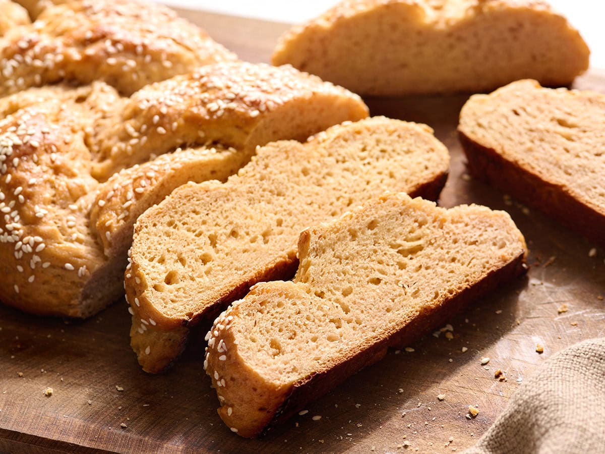 Close up of sliced gluten free challah bread showing the tender crumb and golden crust.