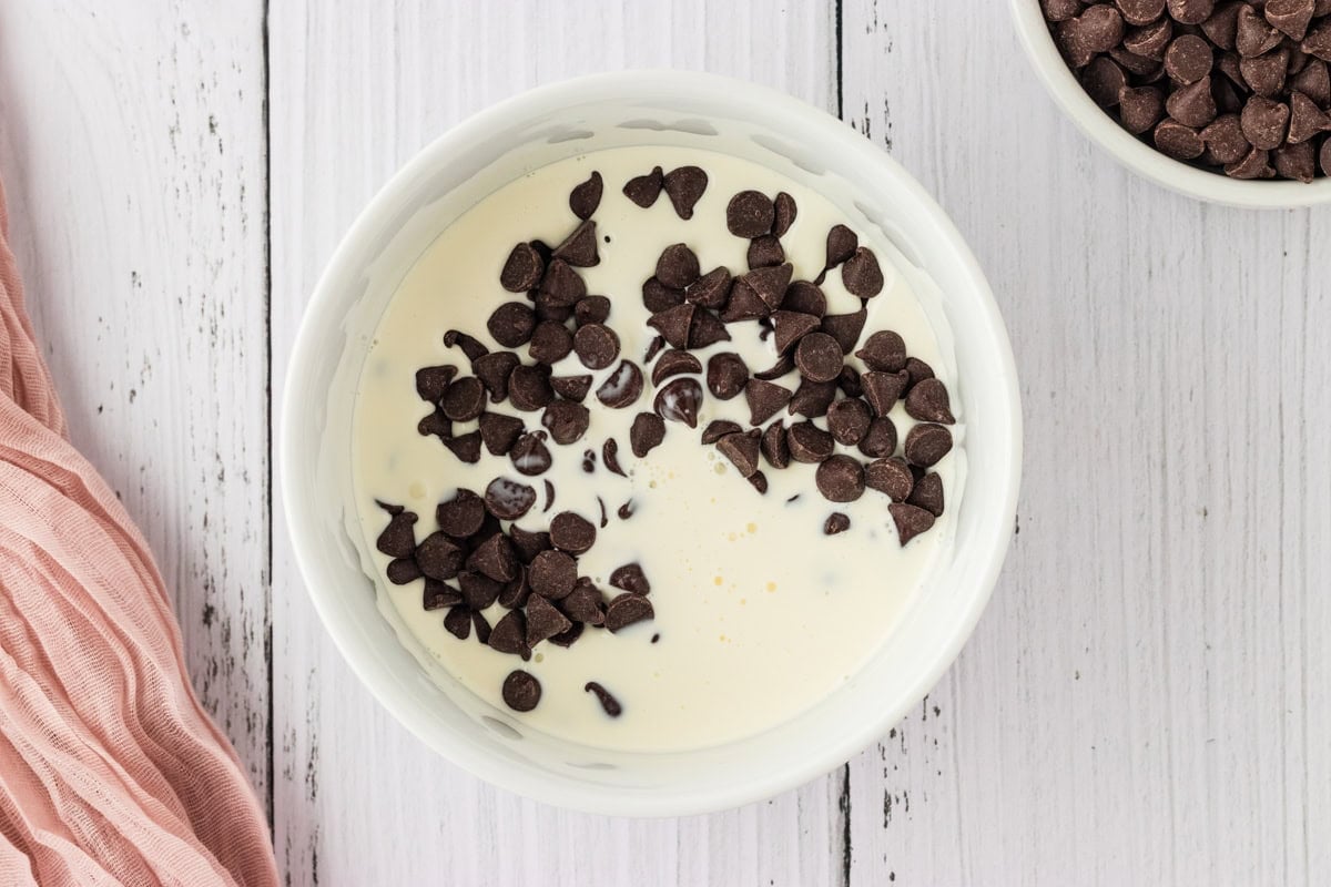 heavy cream with chocolate chips in a white bowl