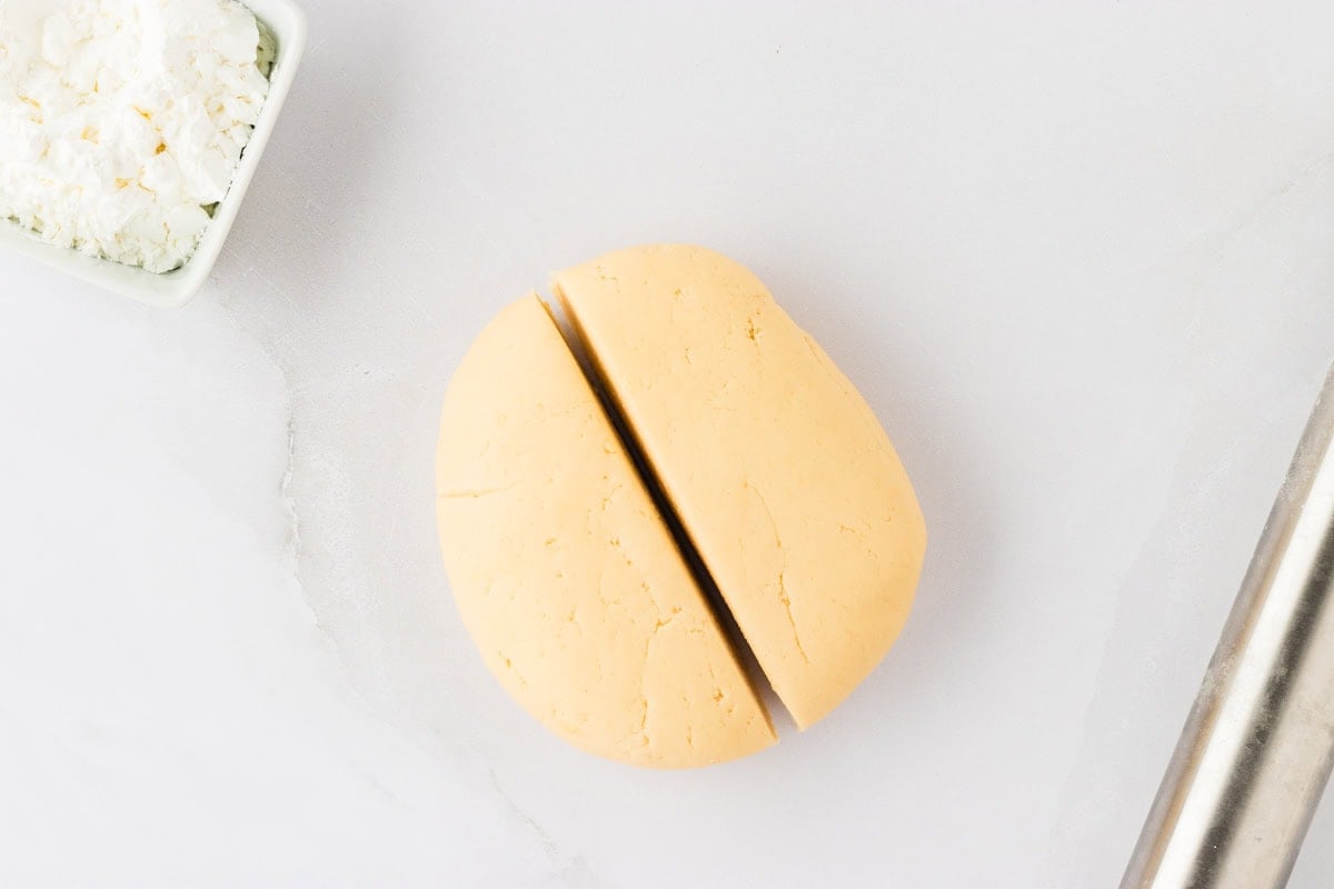 ball of gluten-free egg roll dough cut in 2 equal halves