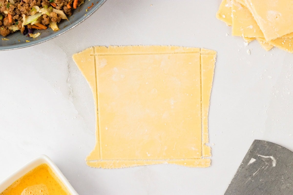 square of gluten-free egg roll dough trimmed into perfect square