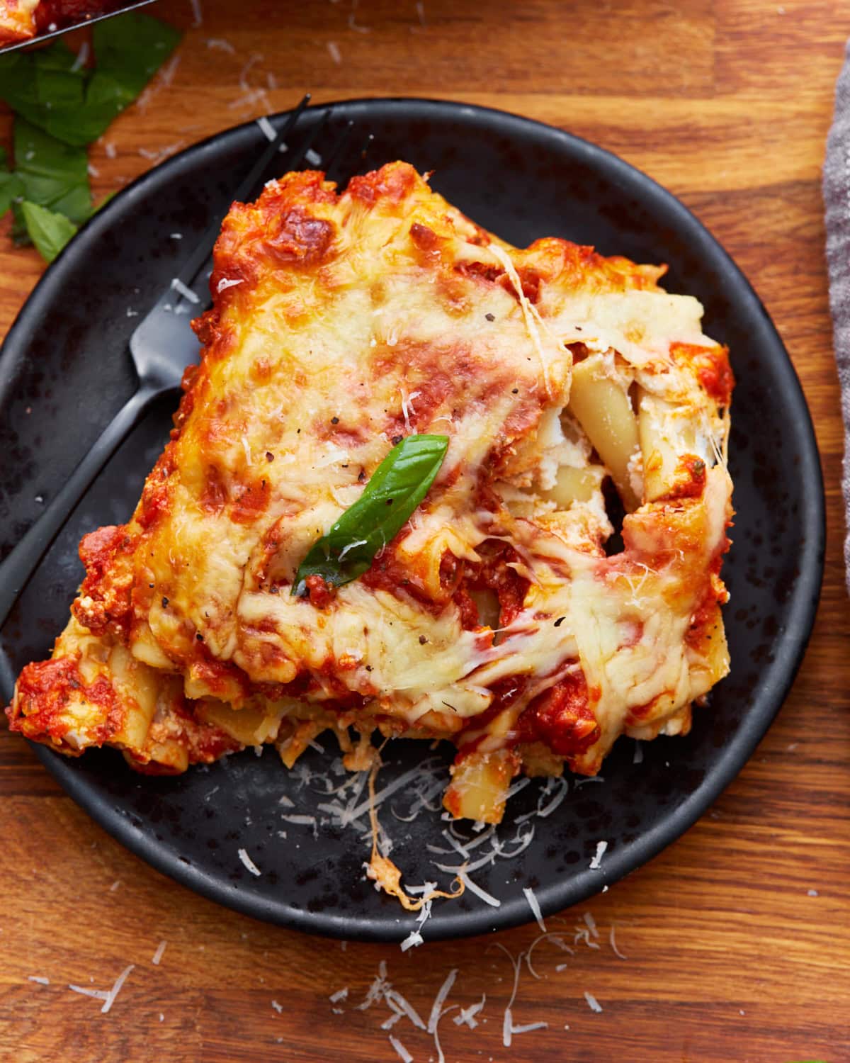 overhead view of some gluten-free baked ziti on a black plate