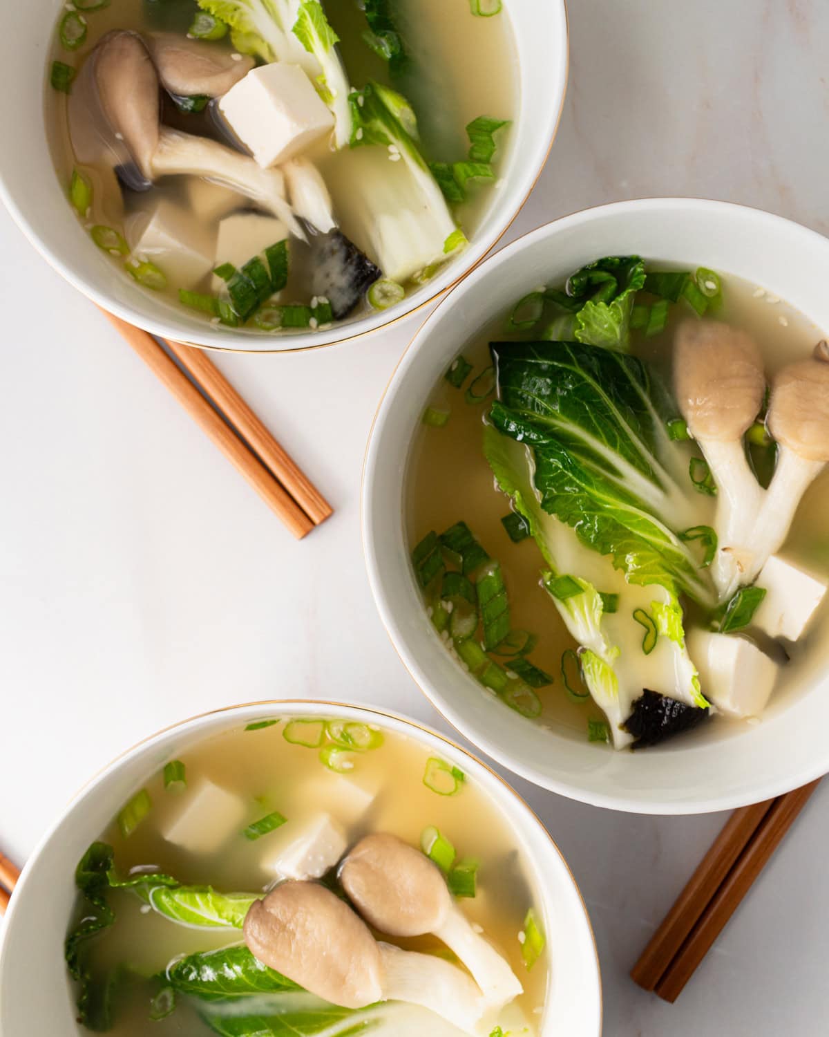3 bowls of gluten free miso soup lined up vertically 