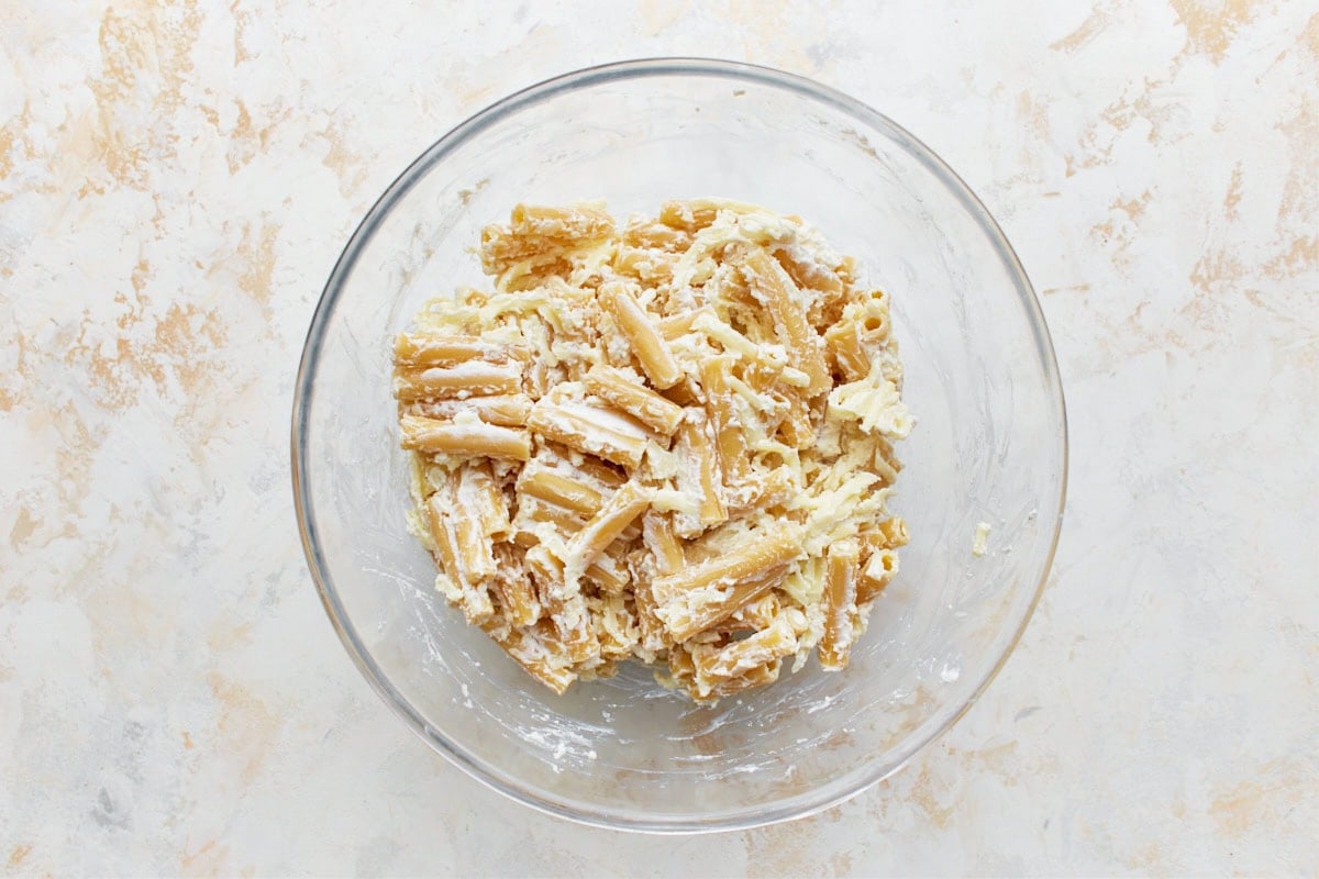cooked gluten-free pasta and cheese mixture in a glass bowl