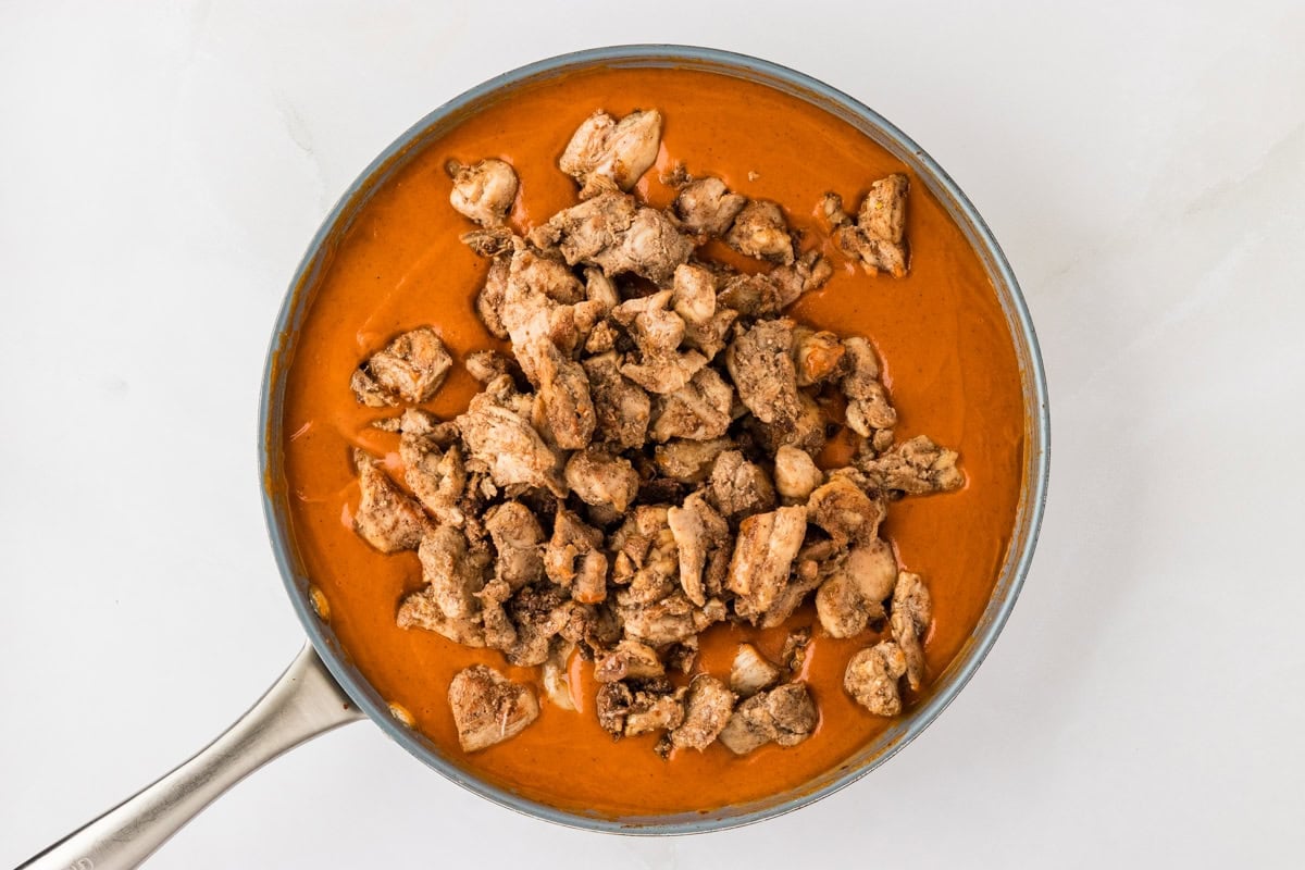 dairy-free butter chicken sauce in a skillet with chicken on top