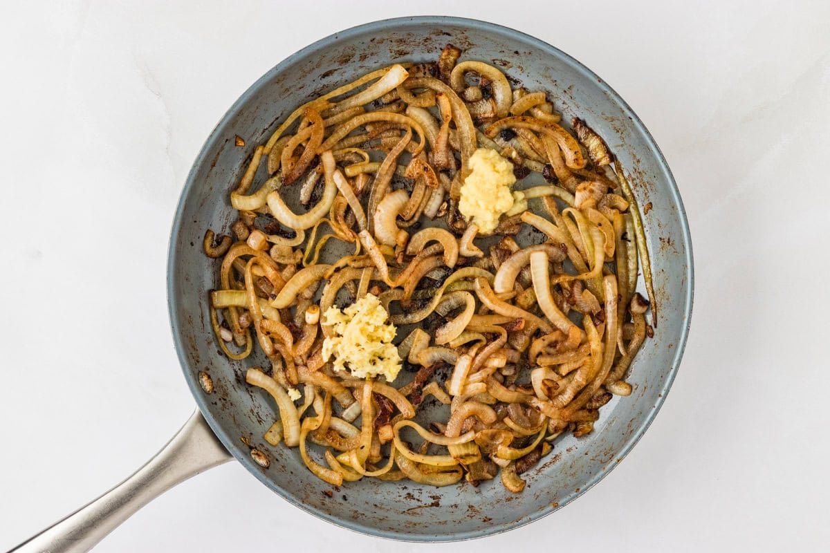 sautéed onion in a skillet with minced garlic and ginger