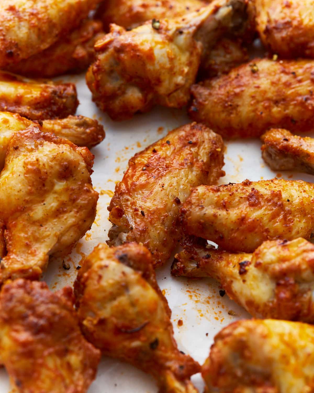 a bunch of crispy gluten-free chicken wings coated in homemade buffalo sauce and seasonings