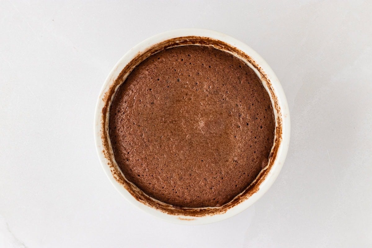 Baked and fluffy gluten-free chocolate lava cake in a white ramekin