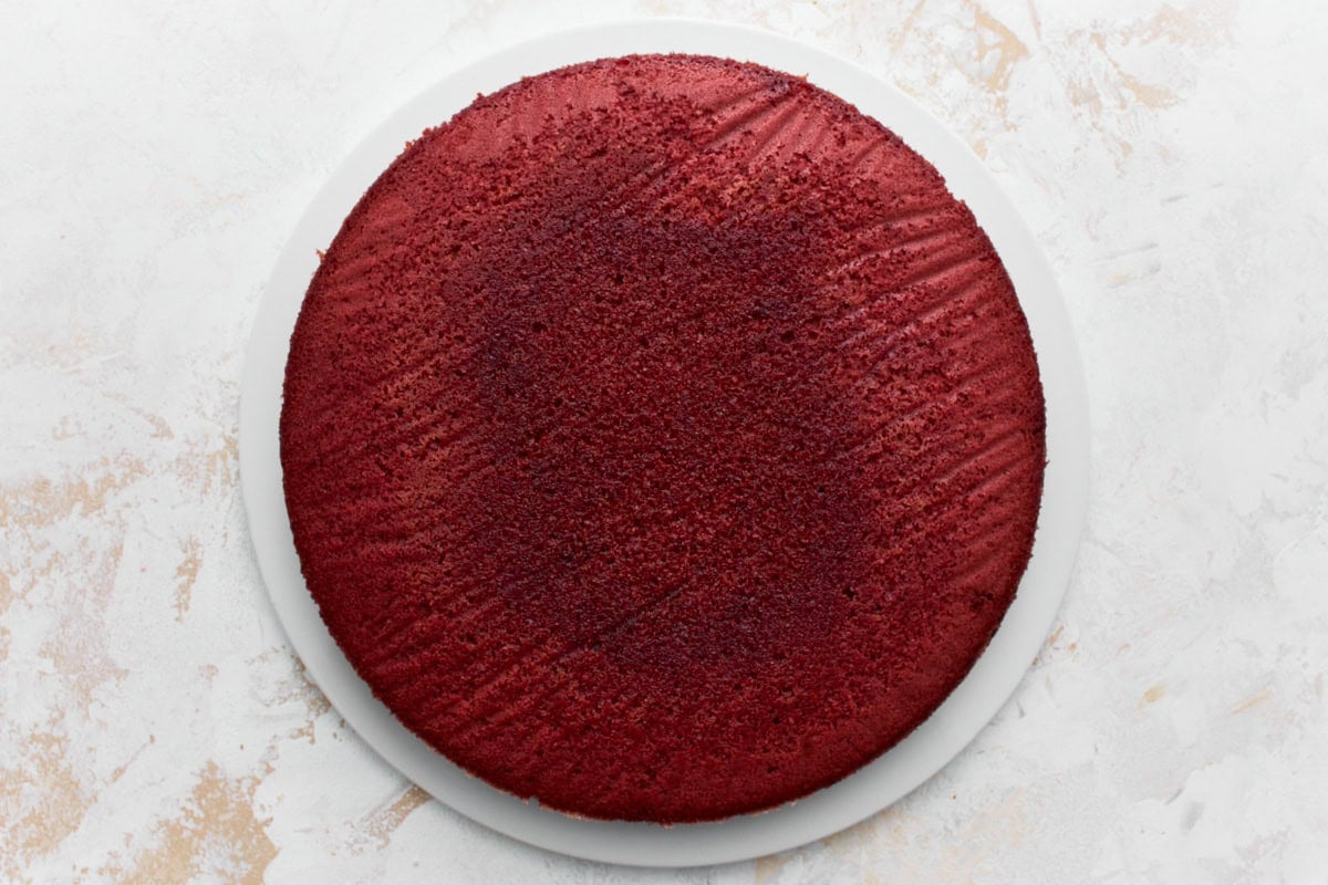 Baked gluten-free re velvet cake on a white cake plate
