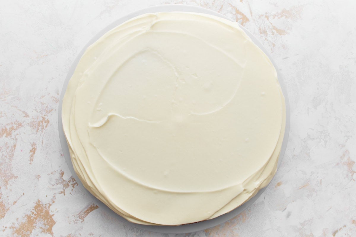 Cake layer frosted with smooth cream cheese frosting