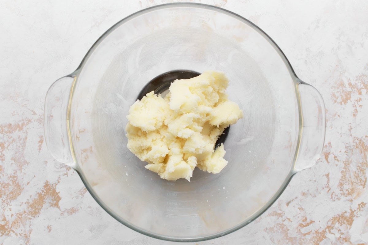 Butter and sugar creamed together in glass mixing bowl