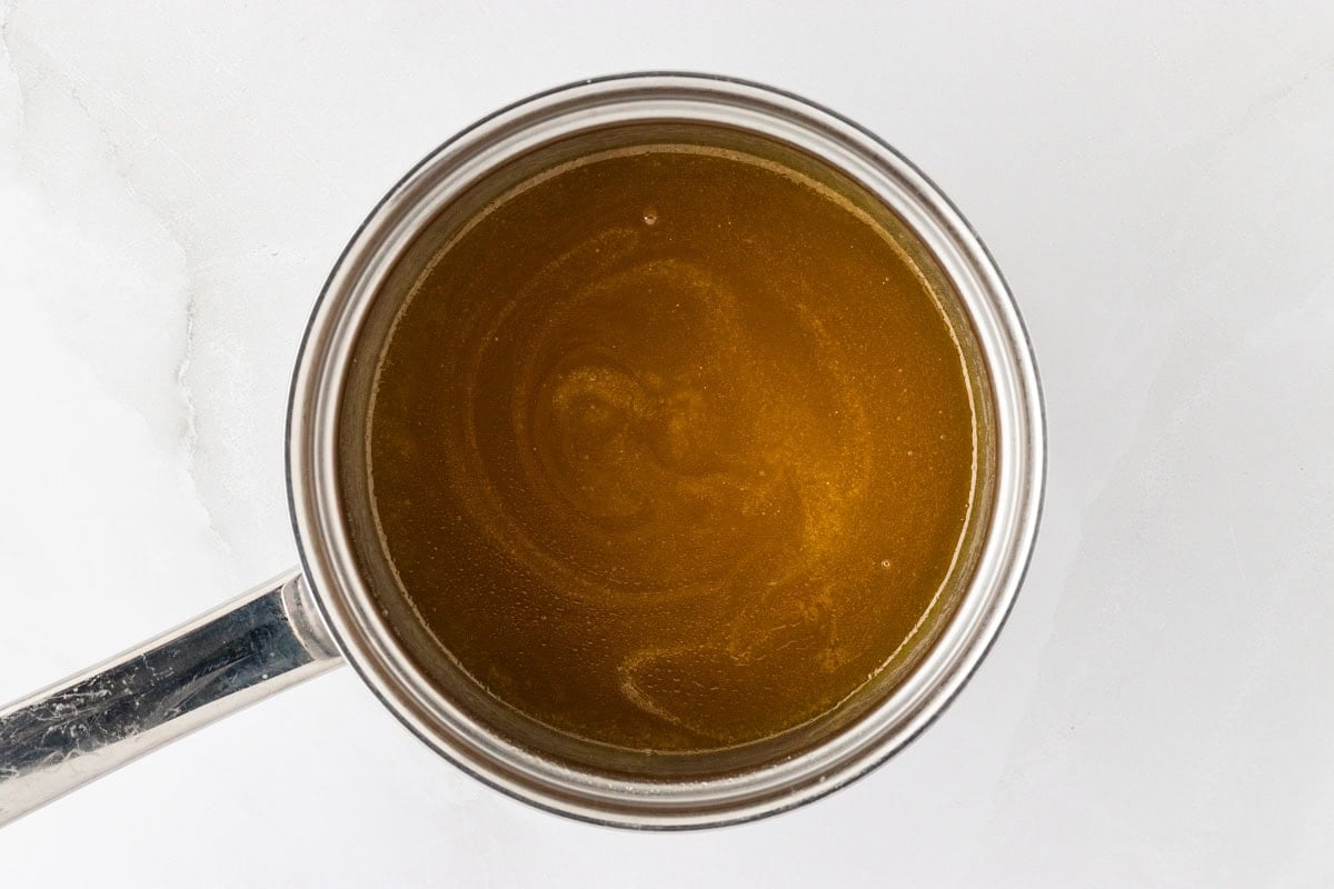 A saucepan containing the rich, buttery glaze for the Kentucky Butter Pound Cake, shown after melting the ingredients together.