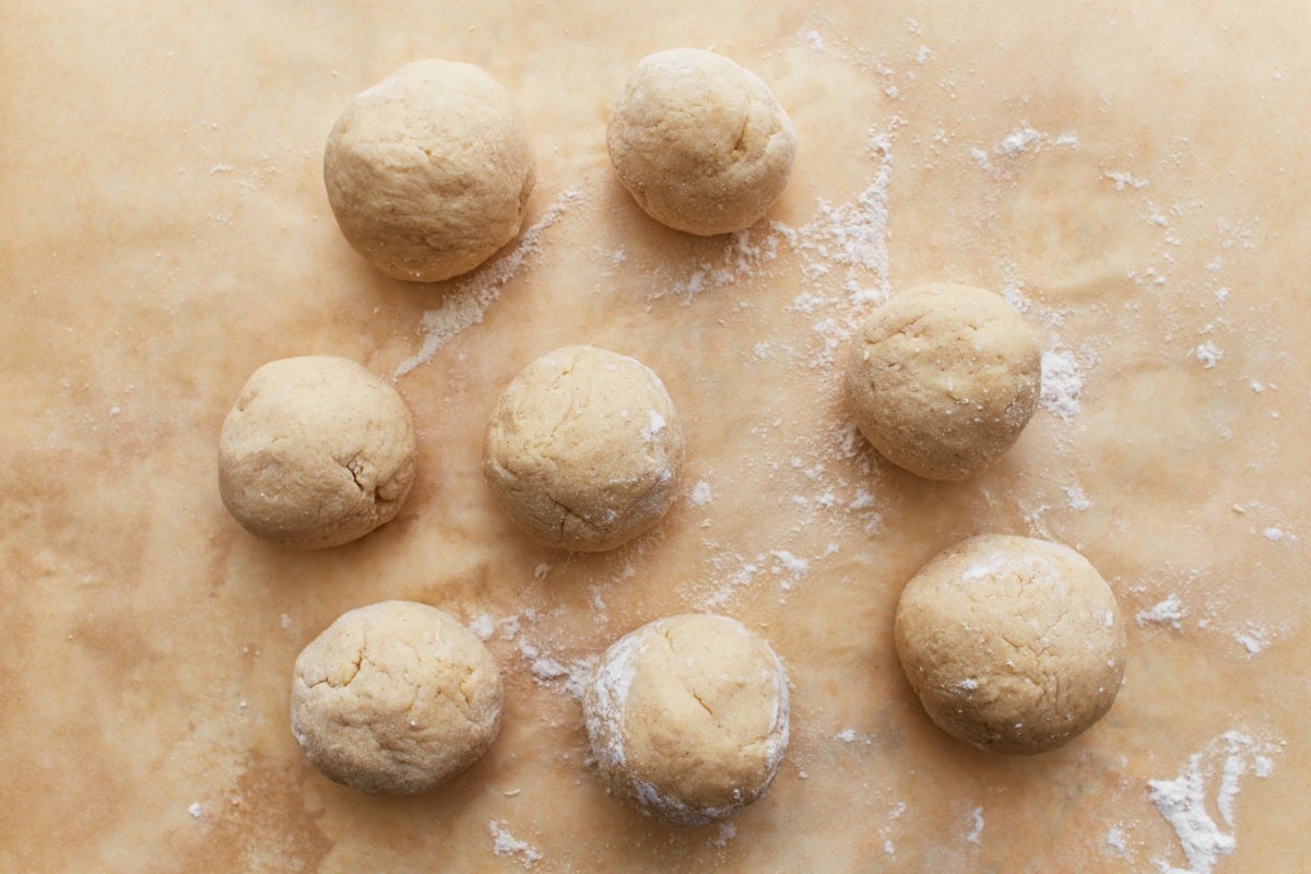 Gluten-free naan dough rolled into small, even balls, ready for shaping and rolling.