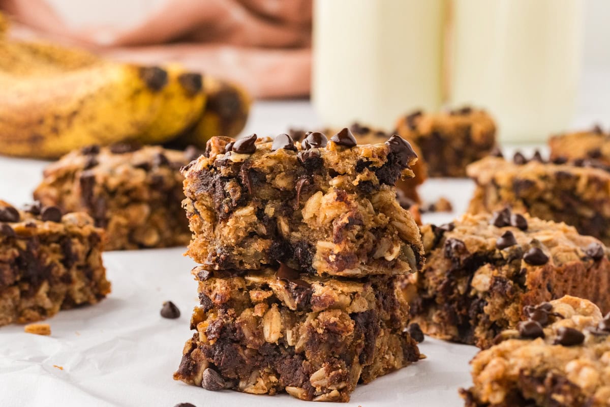 Close-up of two stacked banana oatmeal bars with visible chocolate chips, oats,