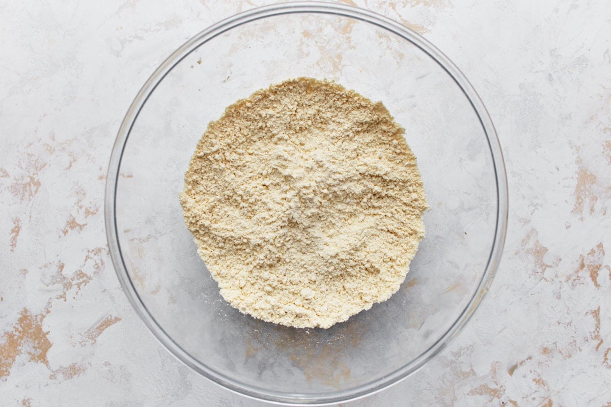 A bowl of dry chickpea flour ready for mixing.