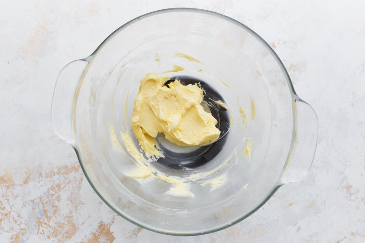 A mixing bowl with softened butter, whipped until smooth and creamy.
