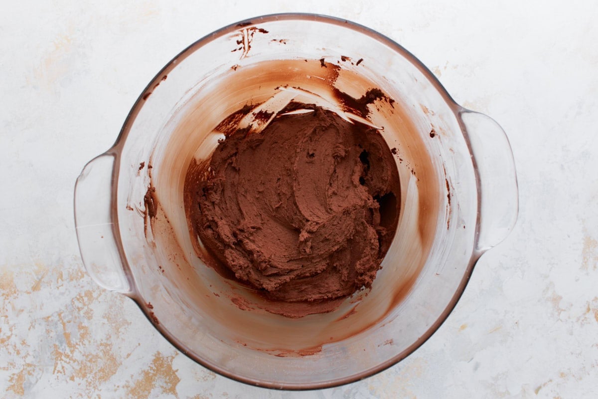 A bowl with rich, thick, and fluffy chocolate buttercream after being fully mixed.
