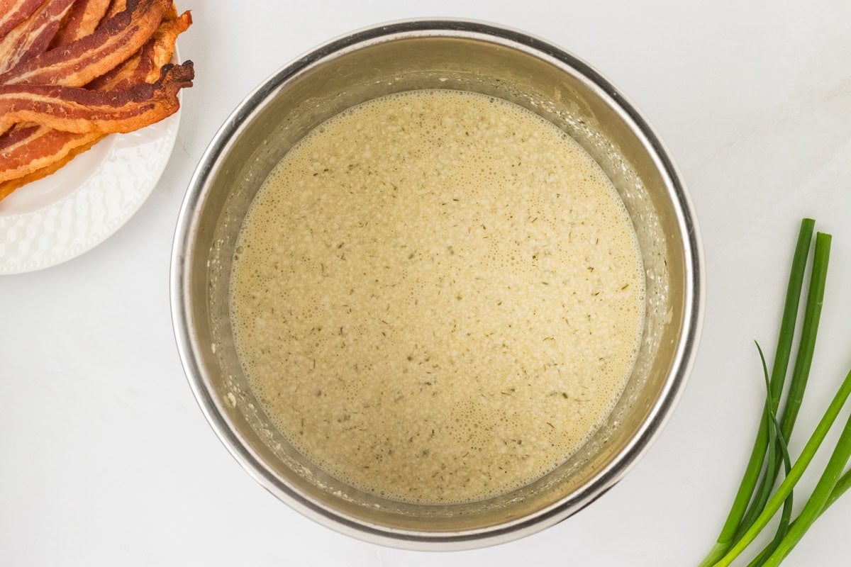 Creamy sauce mixture in the Instant Pot after cooking, before stirring in chicken, cheese, and bacon.