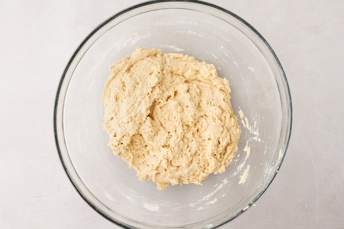 Bowl of mixed cassava bread batter with a light, fluffy texture, ready to be transferred to a loaf pan.