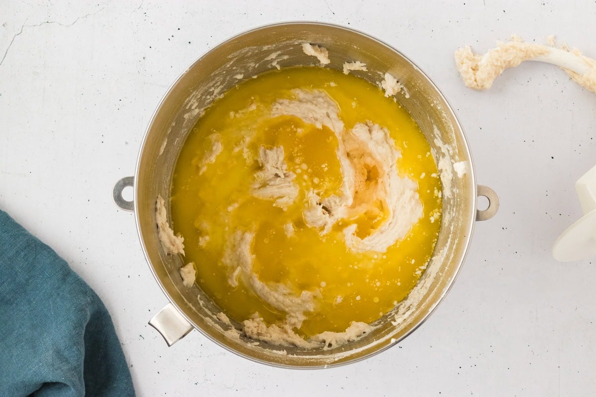 Partially mixed gluten-free dough with melted butter and apple cider vinegar just added, ready to be blended.