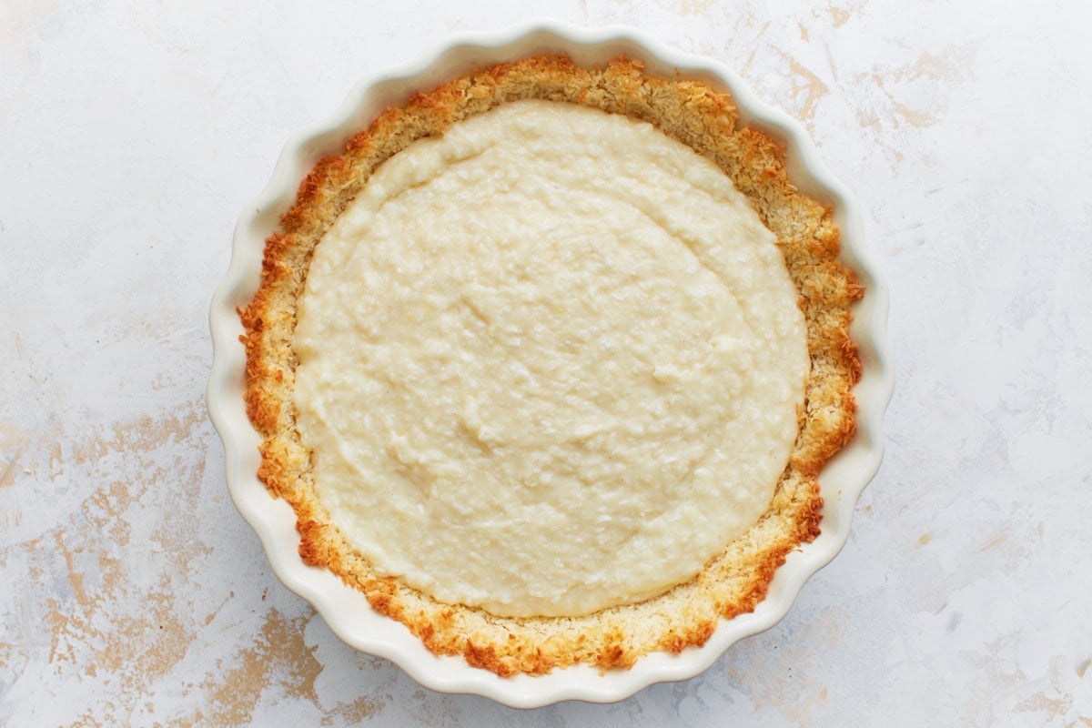 Coconut custard filling spread into the baked coconut crust.