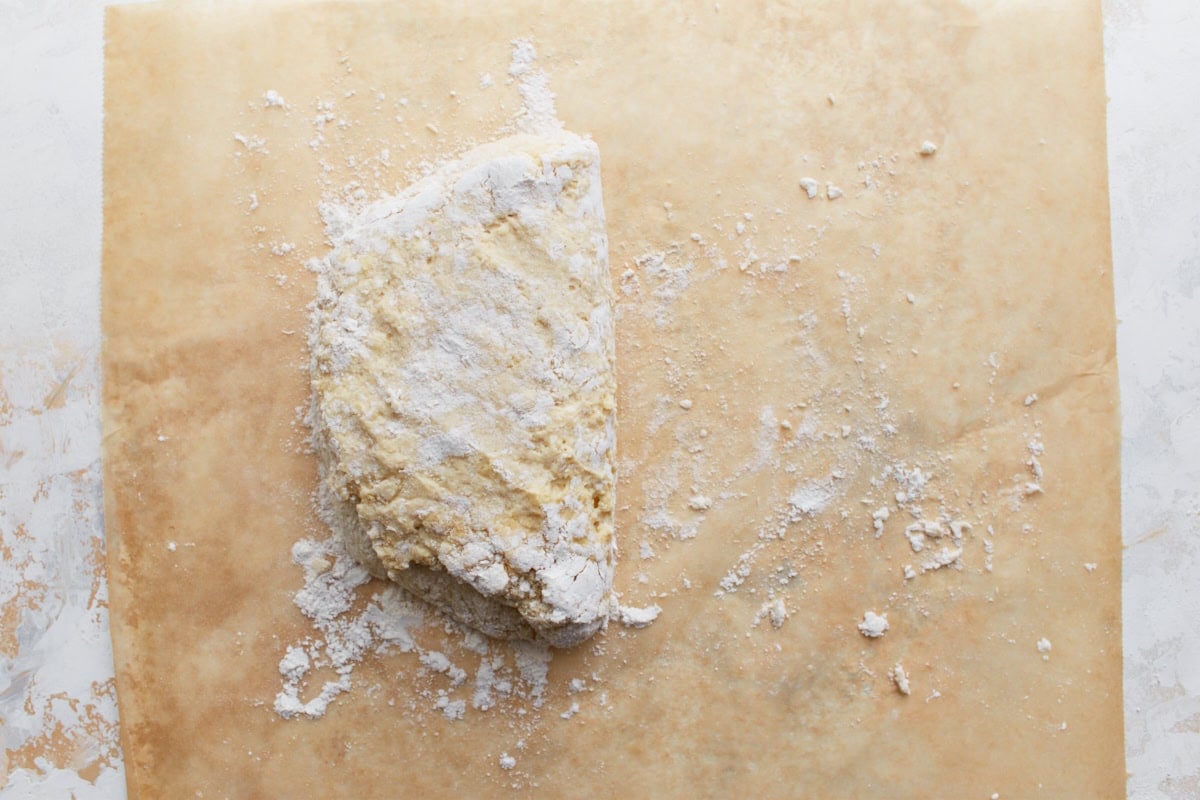 Biscuit dough being folded over on itself to help create layers before shaping.