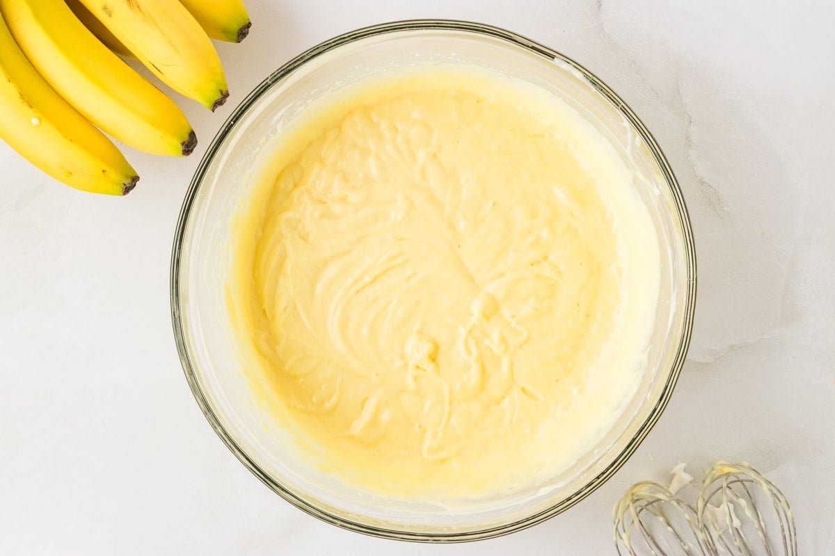 Combined pudding, cream cheese, and whipped cream mixture in a mixing bowl, with a smooth and fluffy texture.