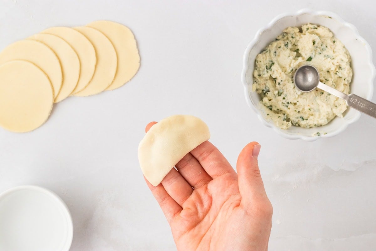 Sealed gluten-free tortellini shaped into a half-moon after pressing edges together
