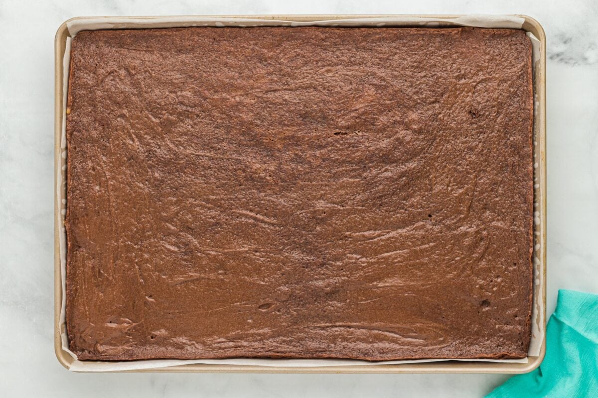 Baked chocolate cookie base, fully set and cooled on a baking sheet lined with parchment paper.