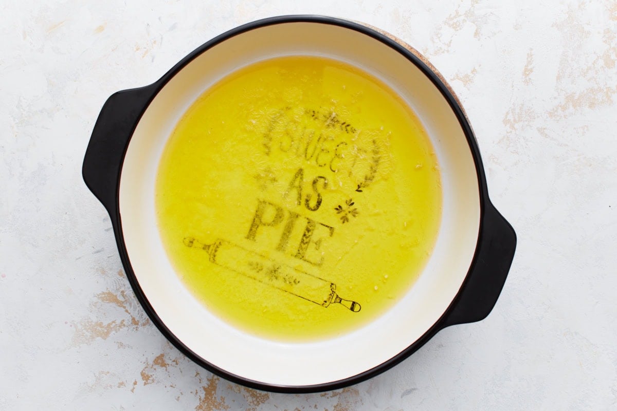 Baking dish with melted butter spread across the bottom.