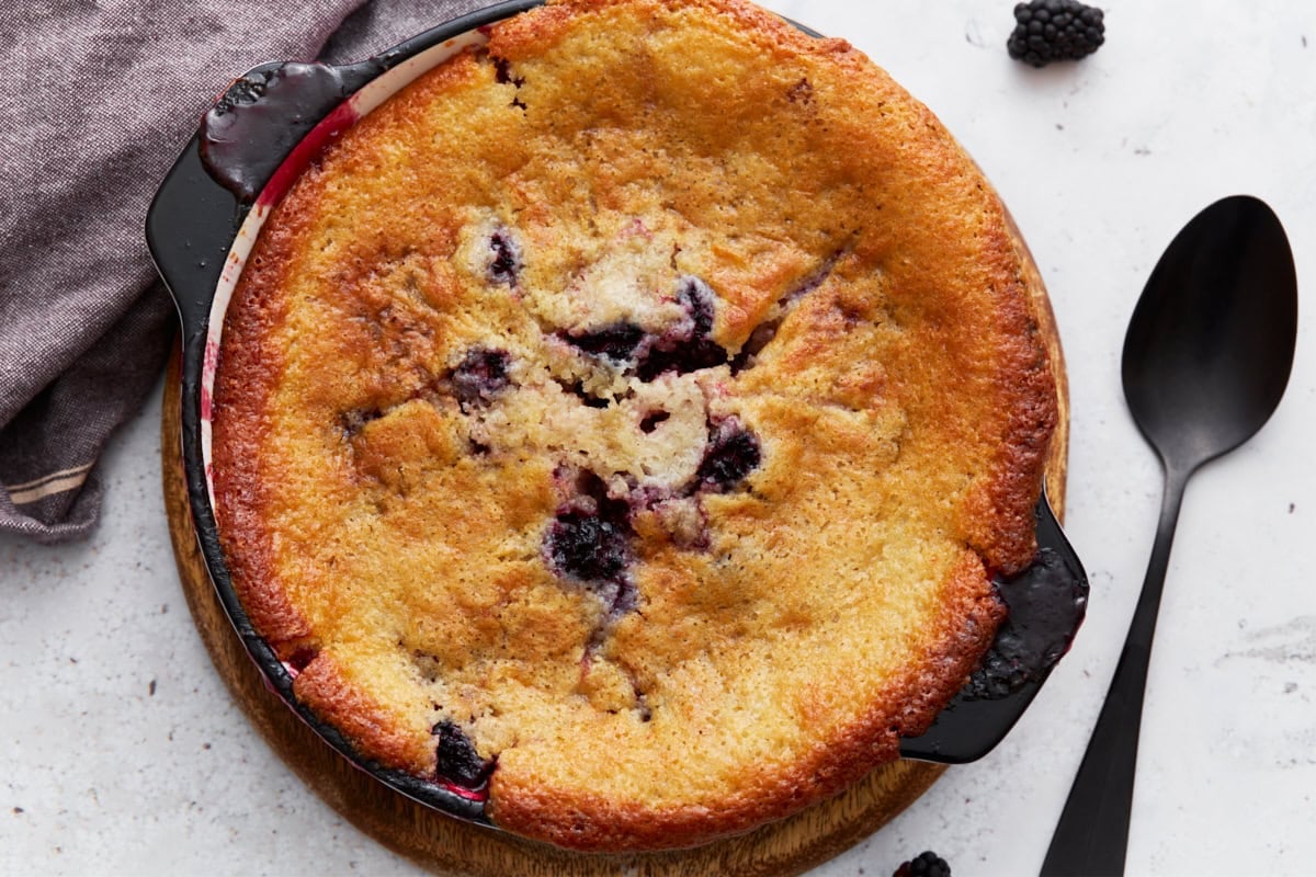 Close-up of the finished gluten-free blackberry cobbler, showing crisp edges and juicy blackberries.